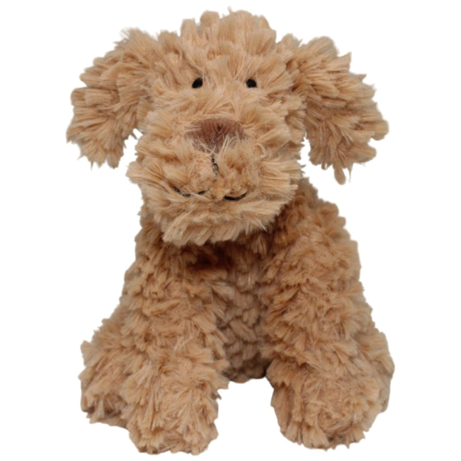 Brauner zotteliger Hund, sitzend