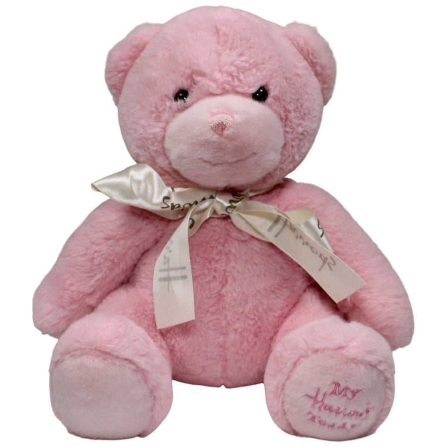 Hübscher rosa Teddybär mit Schleife, sitzend
