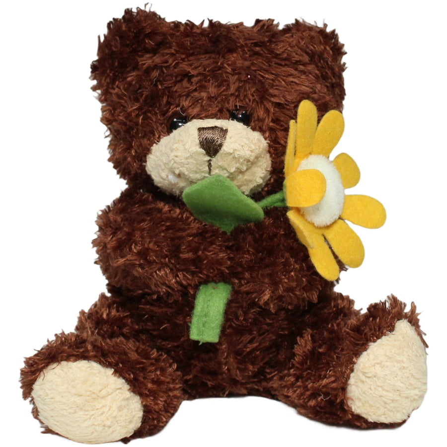 Kleiner Teddybär mit gelber Blume, sitzend