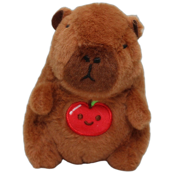 Kleines Capybara mit Apfel auf dem Bauch