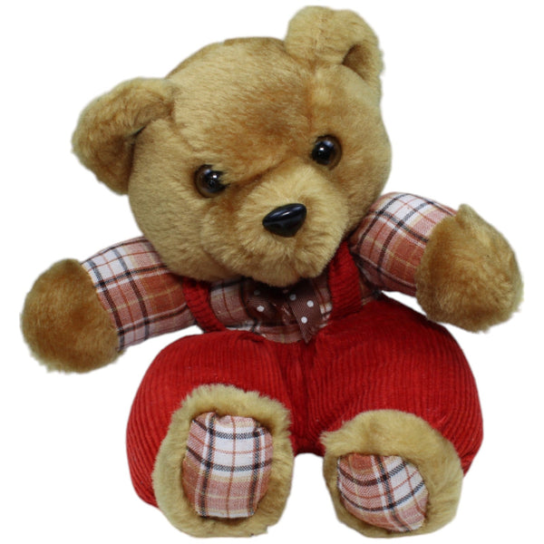 Süßer Teddybär in roter Latzhose