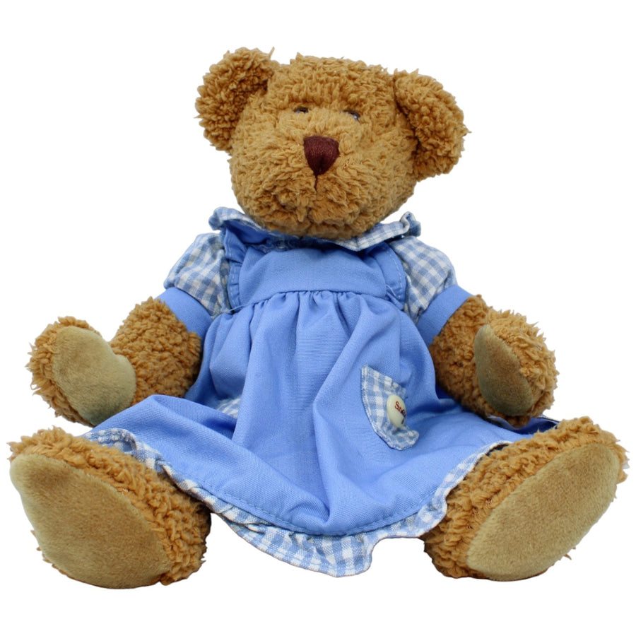 Teddybär in blauem Kleid, sitzend